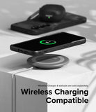 Galaxy S24 Case | Onyx Design - Black phone in textured case wirelessly charging on a pad with earbuds in the background.