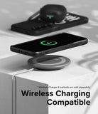 Galaxy S24 Case | Onyx Design - Black phone in Onyx case wirelessly charging on a pad with earbuds in the background.