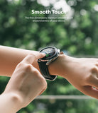 Galaxy Watch 3 45mm Screen Protector | Glass - A person touching the screen of a Galaxy Watch 3 against a blurred green background.