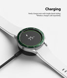 Galaxy Watch 4 Classic 42mm | Bezel Styling - A silver smartwatch with a green bezel ring charging on a wireless dock.
