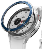 Galaxy Watch 4 Classic 42mm | Bezel Styling - A blue metallic bezel ring hovering above a silver smartwatch with a white band.