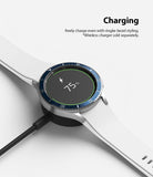 Galaxy Watch 4 Classic 42mm | Bezel Styling - A Galaxy Watch with a blue bezel ring charging wirelessly at 75% battery.
