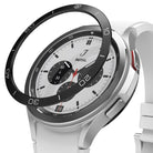 Galaxy Watch 4 Classic 42mm | Bezel Styling - Black adhesive bezel ring hovering above a silver smartwatch with white band.