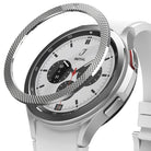 Galaxy Watch 4 Classic 42mm | Bezel Styling - Galaxy Watch 4 Classic 42mm - A textured silver metal bezel ring hovering above a white smartwatch with a chronograph face.