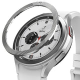 Galaxy Watch 4 Classic 42mm | Bezel Styling - Galaxy Watch 4 Classic 42mm - A textured silver metal bezel ring hovering above a white smartwatch with a chronograph face.