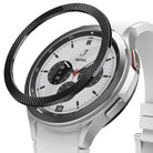 Galaxy Watch 4 Classic 42mm | Bezel Styling - A black textured bezel ring hovering above a silver smartwatch with a white band.