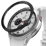 Galaxy Watch 4 Classic 42mm | Bezel Styling - A black textured bezel ring hovering above a silver smartwatch with a white band.