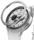 Galaxy Watch 4 Classic 42mm | Bezel Styling - Galaxy Watch 4 Classic 42mm | A silver metal bezel ring hovering above a white Galaxy Watch 4 Classic with a white band.