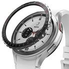 Galaxy Watch 4 Classic 42mm | Bezel Styling - Galaxy Watch 4 Classic 42mm - Black tachymeter bezel styling hovering above a silver smartwatch with a white strap.