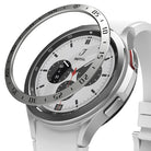 Galaxy Watch 4 Classic 46mm | Bezel Styling - A metallic bezel ring hovering above a silver smartwatch with a white band.