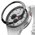 Galaxy Watch 4 Classic 46mm | Bezel Styling - A black numbered bezel ring hovering above a silver smartwatch with a white band.