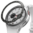 Galaxy Watch 4 Classic 46mm | Bezel Styling - Galaxy Watch 4 Classic 46mm | Black tachymeter bezel ring hovering above a silver smartwatch with a white chronograph face.