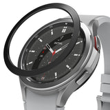 Galaxy Watch 4 Classic 46mm | Bezel Styling - A black adhesive bezel ring hovering above a silver Galaxy Watch 4.