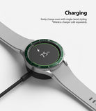 Galaxy Watch 4 Classic 46mm | Bezel Styling - Smartwatch with green bezel styling charging on a wireless dock.