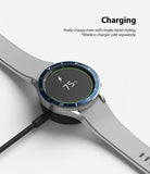 Galaxy Watch 4 Classic 46mm | Bezel Styling - Smartwatch with blue bezel styling charging on a wireless dock.