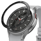 Galaxy Watch 4 Classic 46mm | Bezel Styling - A black adhesive bezel ring hovering above a silver Galaxy Watch 4.
