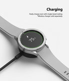 Galaxy Watch 4 Classic 46mm | Bezel Styling - Silver smartwatch with bezel styling charging on a wireless dock.