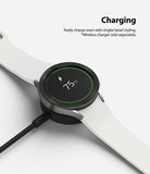 Galaxy Watch 5 / 4 (40mm) | Bezel Premium Styling - Smartwatch with textured black bezel charging on a wireless dock.
