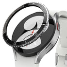 Galaxy Watch 5 / 4 (40mm) | Bezel Premium Styling - Black adhesive bezel ring hovering above a silver Galaxy Watch.