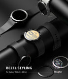 Galaxy Watch 5/4 44mm | Bezel Styling - Black smartwatches on a display stand with metallic bezel accessories.