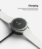 Galaxy Watch 5/4 44mm | Bezel Styling - A smartwatch with a silver bezel accessory charging on a wireless dock.