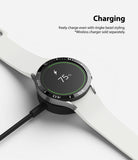 Galaxy Watch 5/4 44mm | Bezel Styling - Smartwatch with black bezel styling charging on a wireless dock at 75%.