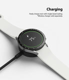 Galaxy Watch 5/4 44mm | Bezel Styling - Smartwatch with black bezel styling charging on a wireless dock at 75 percent.