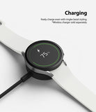 Galaxy Watch 5/4 44mm | Bezel Styling - A smartwatch with a black bezel ring charging on a wireless dock at 75% battery.