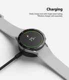 Galaxy Watch 5/4 44mm | Bezel Styling - A smartwatch with a black bezel ring charging wirelessly at 75% battery.
