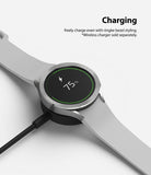 Galaxy Watch 5 / 4 (44mm) | Premium Bezel Styling - Smartwatch with silver bezel styling charging on a wireless dock.