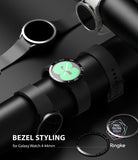 Galaxy Watch 5 / 4 (44mm) | Premium Bezel Styling - Black Galaxy Watch with a metallic bezel ring on a display stand.