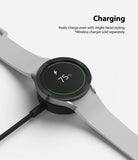 Galaxy Watch 5 / 4 (44mm) | Premium Bezel Styling - Smartwatch with textured bezel ring charging on a wireless dock.