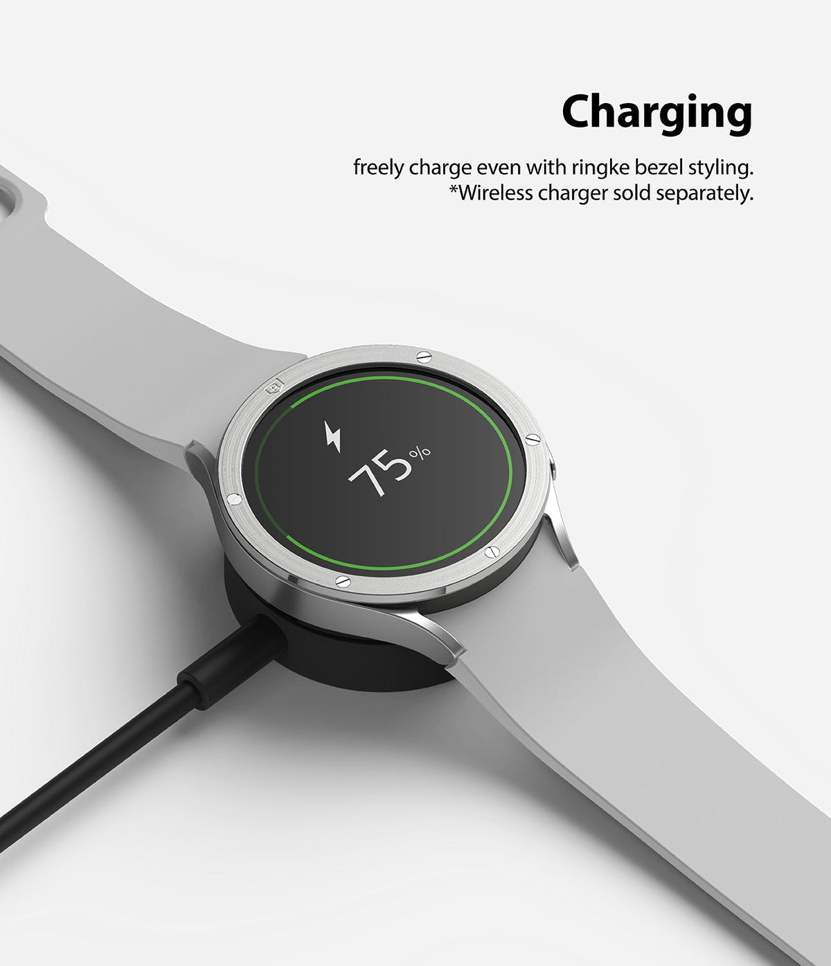 Galaxy Watch 5 / 4 (44mm) | Premium Bezel Styling - Smartwatch with silver bezel styling charging on a wireless dock.