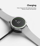 Galaxy Watch 5 / 4 (44mm) | Premium Bezel Styling - Smartwatch with silver bezel styling charging on a wireless dock.