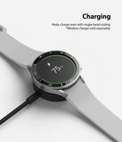 Galaxy Watch 5 / 4 (44mm) | Premium Bezel Styling - Smartwatch with bezel styling on a wireless charger showing 75% battery.