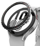 Galaxy Watch 5 / 4 (44mm) | Premium Bezel Styling - A metallic, notched bezel ring hovering above a silver smartwatch.