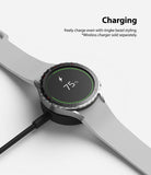 Galaxy Watch 5 / 4 (44mm) | Premium Bezel Styling - Smartwatch with silver bezel ring charging on a wireless dock.