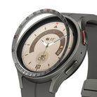 Galaxy Watch 5 Pro 45mm | Inner Bezel Styling - Galaxy Watch 5 Pro 45mm - A metallic bezel ring with tachymeter markings hovering above a grey smartwatch face.