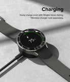 Galaxy Watch 5 Pro (45mm) | Premium Bezel Styling - Smartwatch with black bezel styling charging on a wireless dock.