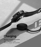 Galaxy Watch 5 Pro Case | Slim - A Galaxy Watch 5 Pro with a slim case hovering above a wireless charging puck on a gray surface.