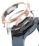 Galaxy Watch 5 44mm Case | Slim - Rose gold and clear protective watch cases hovering above a blue Galaxy Watch 5.