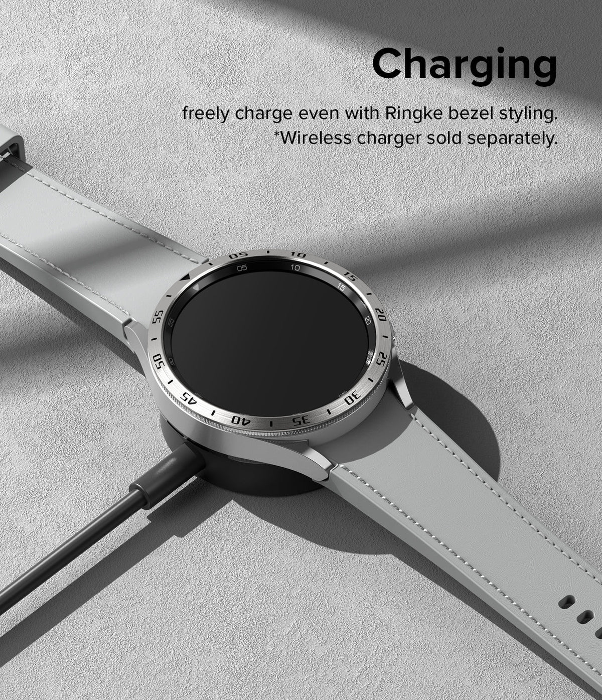 Galaxy Watch 6 Classic 43mm | Bezel Styling - Silver smartwatch with a numbered bezel ring charging on a wireless dock.