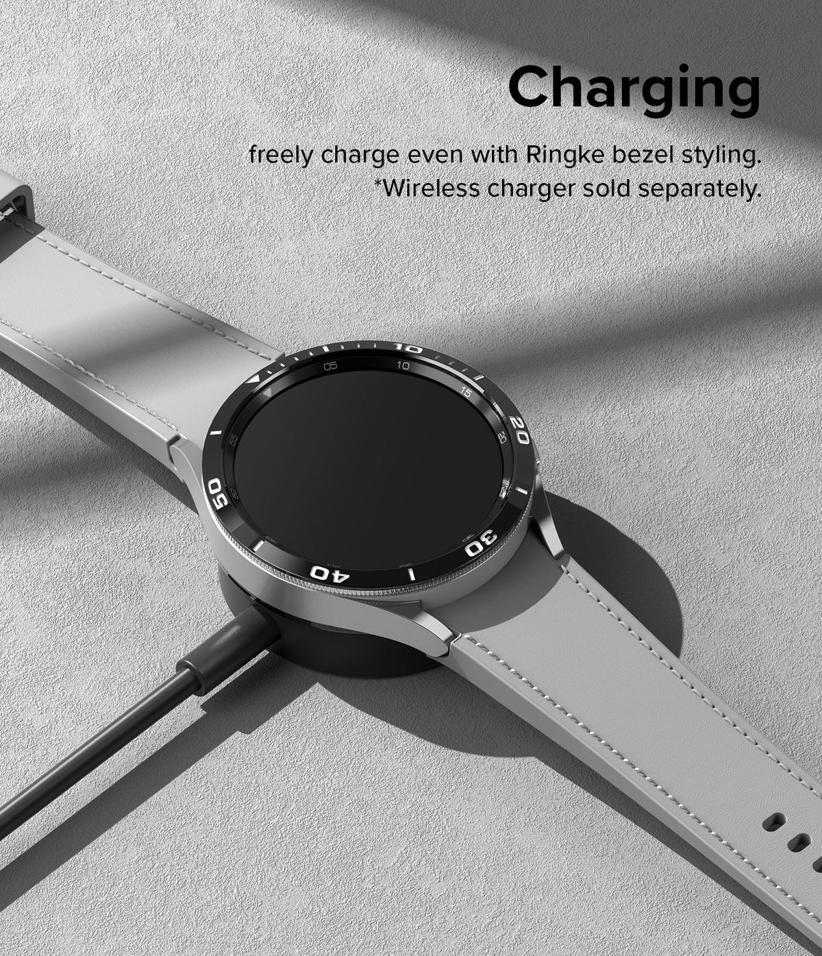 Galaxy Watch 6 Classic 43mm | Bezel Styling - Smartwatch with black bezel styling charging on a wireless dock.