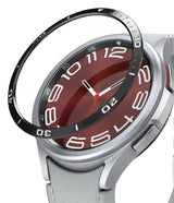 Galaxy Watch 6 Classic 47mm | Bezel Styling - A black adhesive bezel ring hovering above a silver smartwatch face.