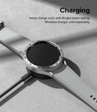 Forerunner 955 | Bezel Styling - Smartwatch with silver bezel styling on a wireless charging pad against a gray background.