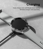 Forerunner 955 | Bezel Styling - A smartwatch with a black bezel accessory charging wirelessly on a gray surface.