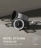 Galaxy Watch 6 Classic 47mm | Premium Bezel Styling - Two smartwatches with metallic bezel accessories on a gray surface.
