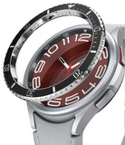 Galaxy Watch 6 Classic 47mm | Premium Bezel Styling - Galaxy Watch 6 Classic 47mm - A black metallic bezel ring hovering above a silver smartwatch with a red analog watch face.