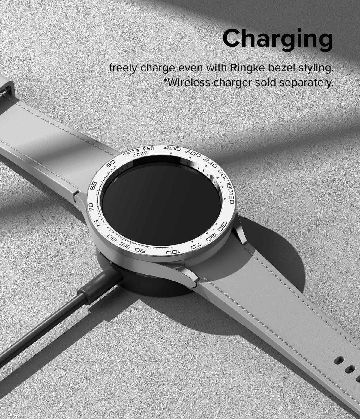 Galaxy Watch 6 Classic 47mm | Premium Bezel Styling - Silver smartwatch with tachymeter bezel charging on a wireless dock.