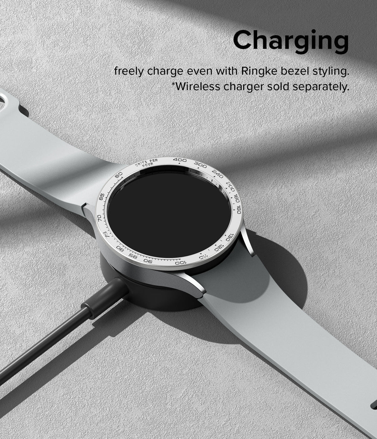 Galaxy Watch 6 (40mm) | Premium Bezel Styling - Silver Galaxy Watch 6 with a tachymeter bezel ring charging on a puck.